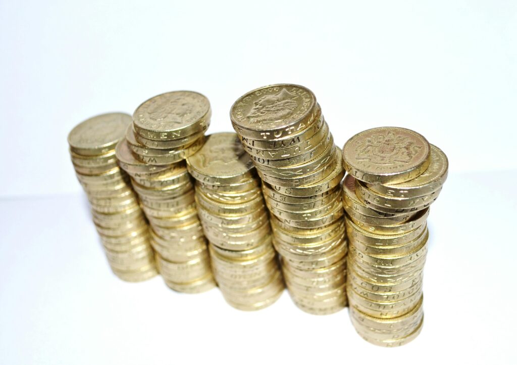 Close-up of stacked gold coins symbolizing wealth and financial growth. Compounding