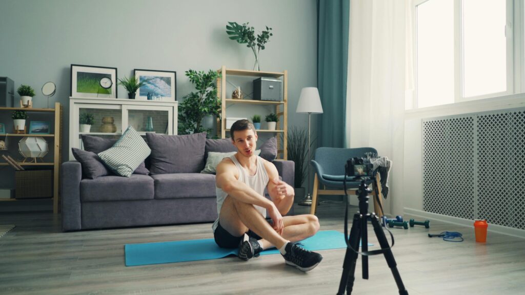 Man doing yoga exercises indoors in a modern living room setting.