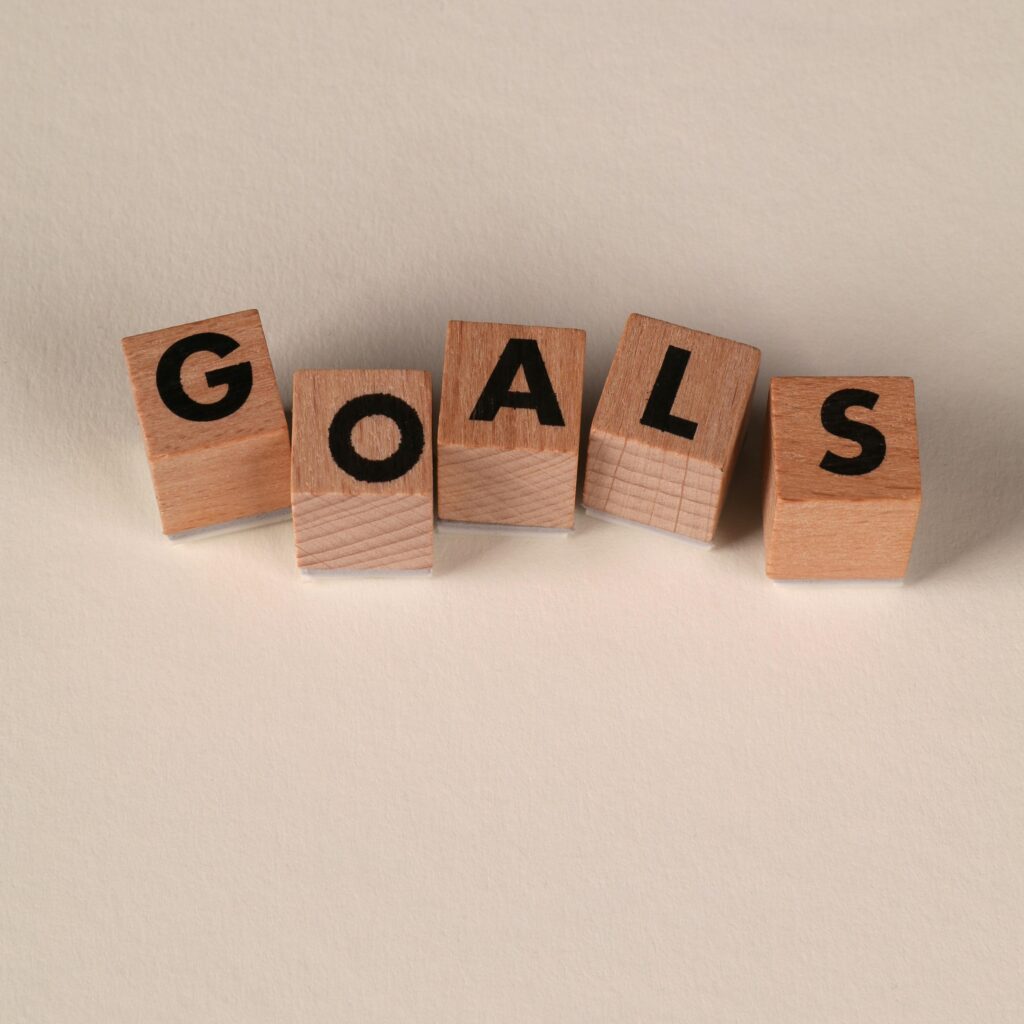 Wooden blocks spell out 'Goals' on a neutral background. Perfect for motivation themes.