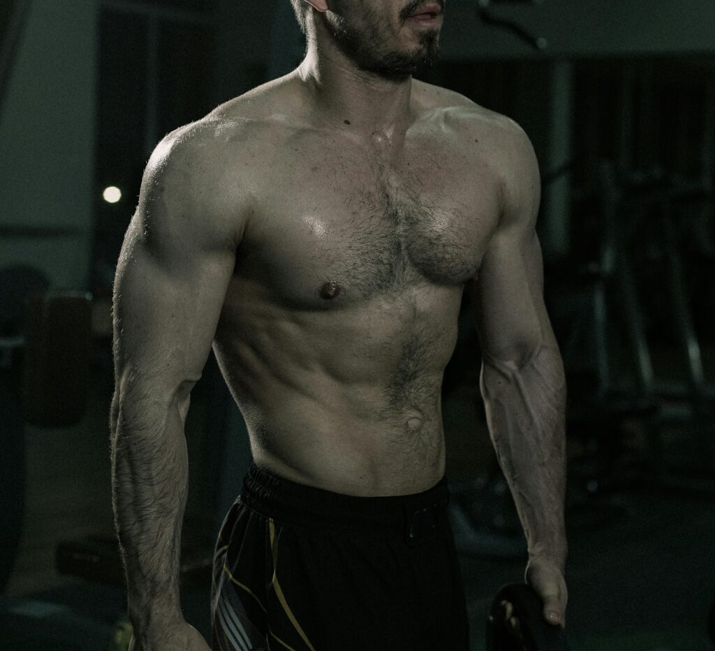 Shirtless man showcasing muscles during a workout in a gym environment.
Muscle Gain