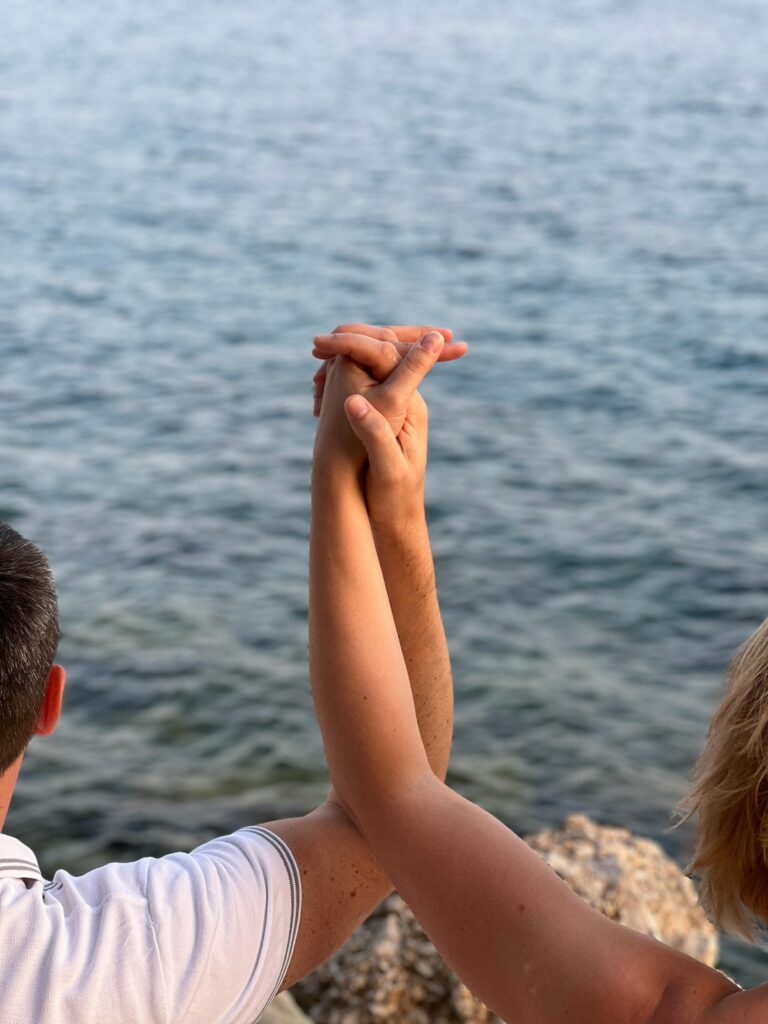A couple's hands intertwined by the serene Adriatic Sea in Croatia, symbolizing unity and love.
Better Relationships