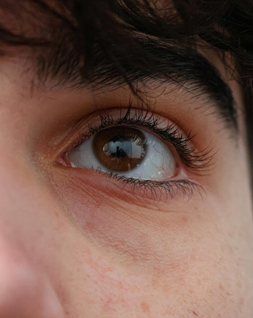 Detailed close-up of a brown eye with a reflection, capturing emotion and curiosity.
Eye Contact