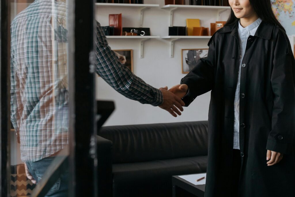 Two professionals engage in a handshake, symbolizing a successful agreement in a contemporary office.