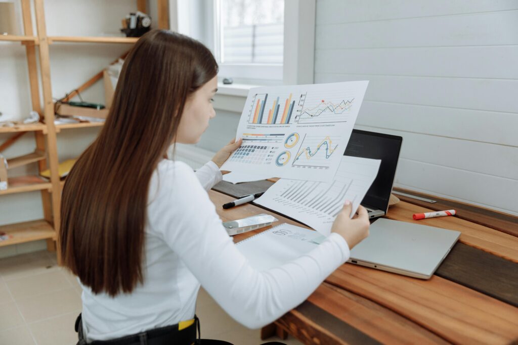 Woman reviewing business charts in a home office setting, showcasing remote work lifestyle.
Self-Analysis