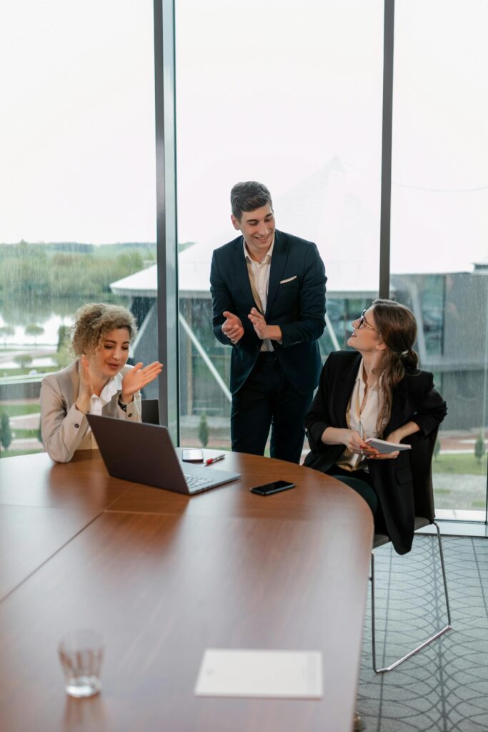 Team of professionals collaborating in an office setting, showcasing a successful meeting.