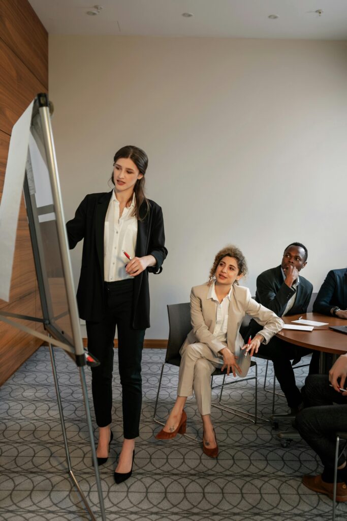 Business meeting with diverse team discussing strategies in a modern conference room.