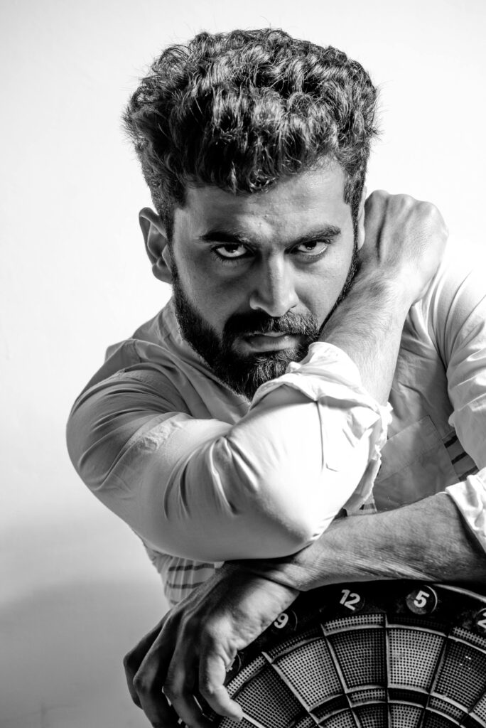 Black and white portrait of a man with a beard and mustache in Delhi, India.
