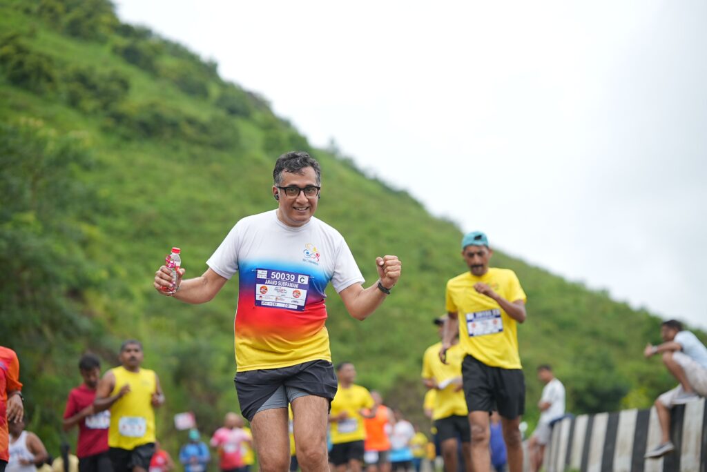 A group of marathon runners enjoying an outdoor race through lush green hills.