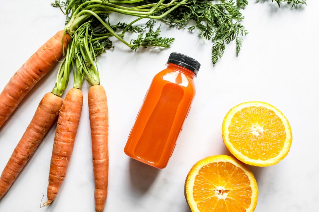 Carrot and orange juice with fresh carrots and sliced orange on a white background.
Dopamine Detox Kaise Kare