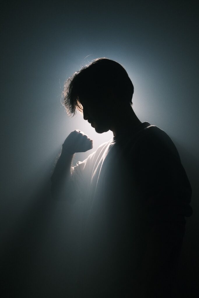 A silhouette of a person in dramatic lighting, highlighting introspection and mystery.