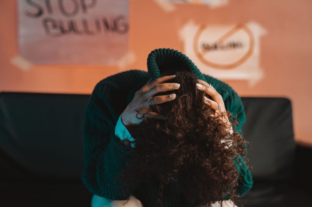 A person in distress, highlighting bullying awareness and mental health issues with a focus on anti-bullying.
